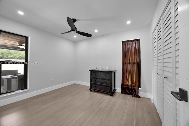 interior space featuring light wood-type flooring, ceiling fan, baseboards, and recessed lighting