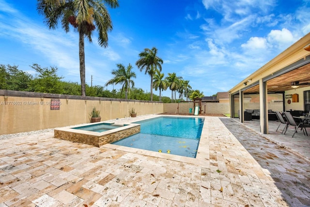 view of pool with a patio area, a fenced backyard, and a pool with connected hot tub