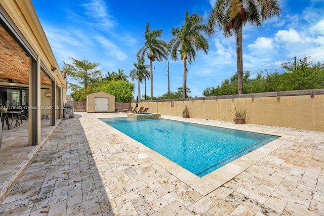 view of pool with a patio area, a storage shed, a fenced backyard, and an outdoor structure