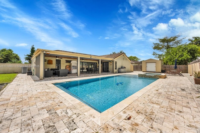 view of pool featuring a patio, a fenced backyard, and an outdoor structure
