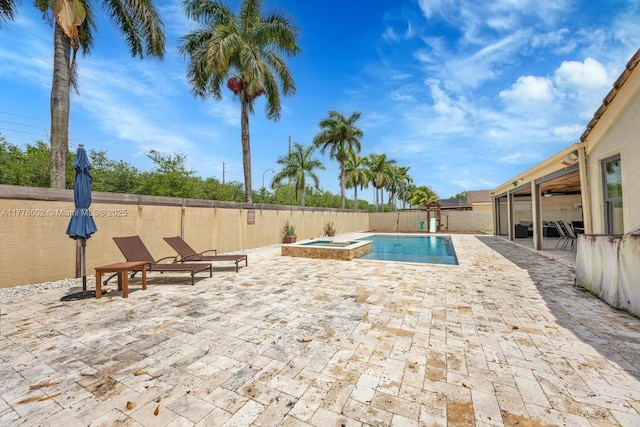view of pool with a patio, a fenced backyard, and a pool with connected hot tub