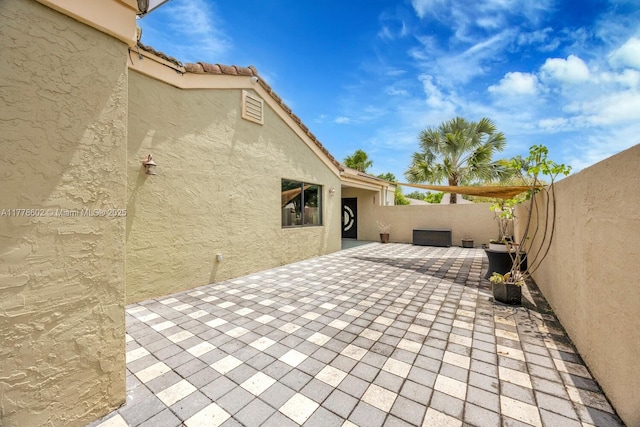 view of patio / terrace featuring fence