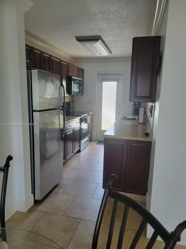 1001 SE 14th Pl Unit 2A, Fort Lauderdale, FL 33316 - kitchen featuring a sink, light countertops, freestanding refrigerator, electric stove, and black microwave