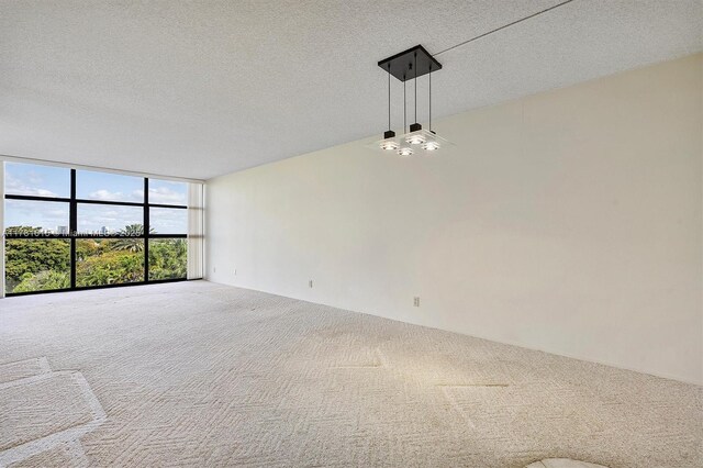 600 Parkview Dr Unit 625, Hallandale Beach, FL 33009 - carpeted empty room featuring visible vents, a textured ceiling, and expansive windows