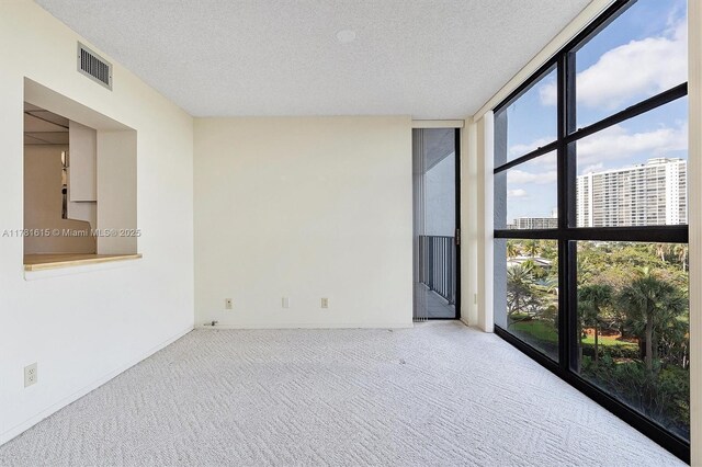 600 Parkview Dr Unit 625, Hallandale Beach, FL 33009 - carpeted spare room featuring a textured ceiling, a view of city, floor to ceiling windows, and visible vents