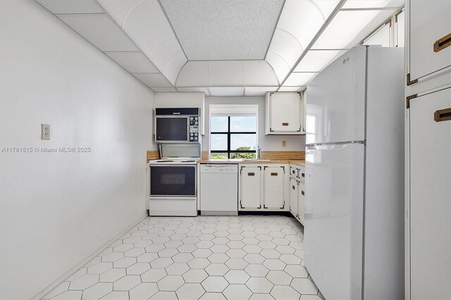 600 Parkview Dr Unit 625, Hallandale Beach, FL 33009 - kitchen with a sink, a paneled ceiling, white appliances, white cabinetry, and wood counters