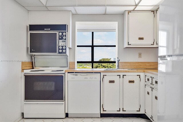 600 Parkview Dr Unit 625, Hallandale Beach, FL 33009 - kitchen featuring white appliances, light countertops, white cabinets, light floors, and a sink