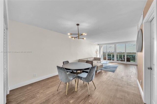 6770 Indian Creek Dr Unit 9G, Miami Beach, FL 33141 - dining room featuring a chandelier and wood finished floors