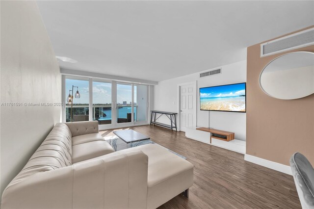 6770 Indian Creek Dr Unit 9G, Miami Beach, FL 33141 - living room featuring wood finished floors and baseboards