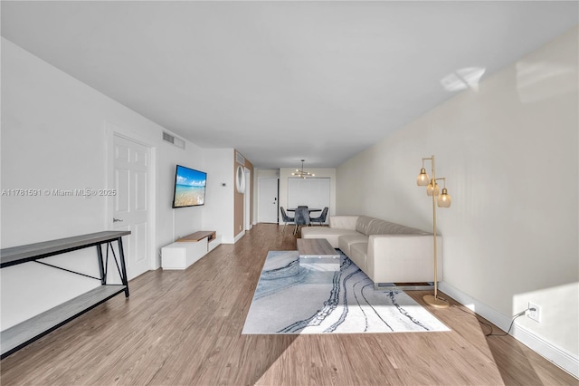 6770 Indian Creek Dr Unit 9G, Miami Beach, FL 33141 - living room with wood finished floors and a chandelier