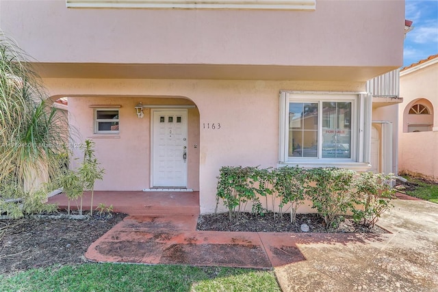 1163 SE 6th Ct, Dania Beach, FL 33004 - doorway to property featuring stucco siding and covered porch