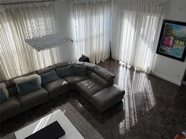 living area featuring a healthy amount of sunlight and baseboards