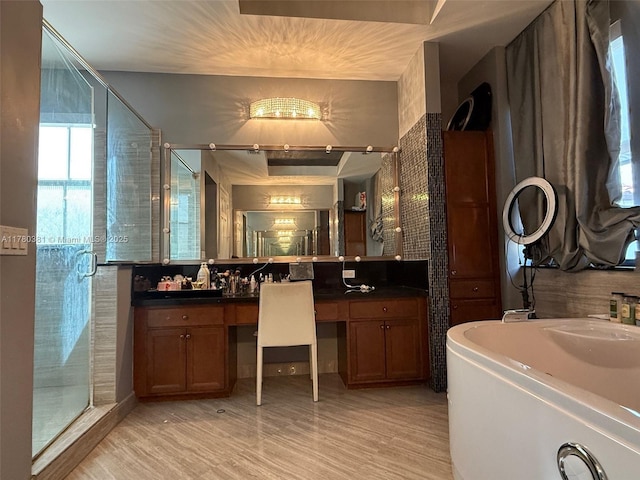 full bath with a stall shower, wood finished floors, and vanity