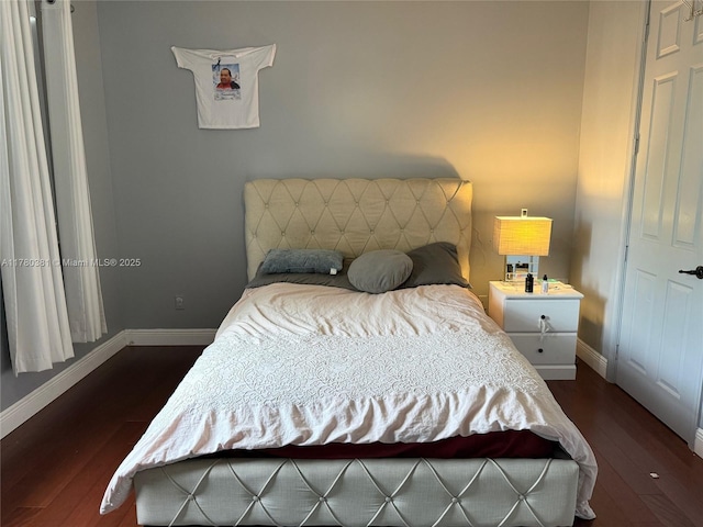 bedroom featuring baseboards and dark wood-style floors