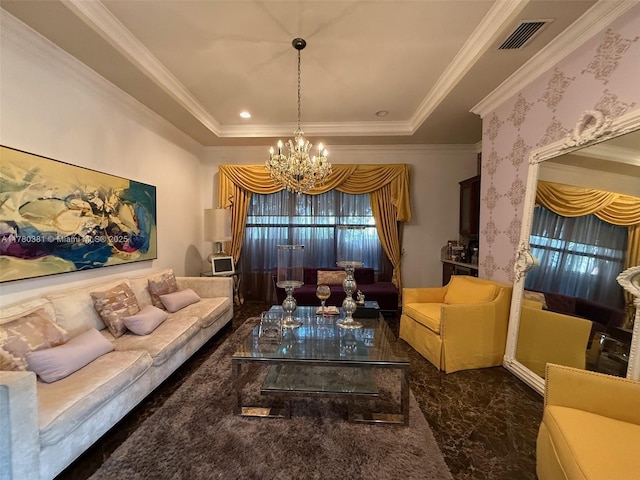 living room with visible vents, an inviting chandelier, ornamental molding, and a raised ceiling