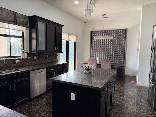 kitchen featuring a sink, dark cabinetry, and appliances with stainless steel finishes