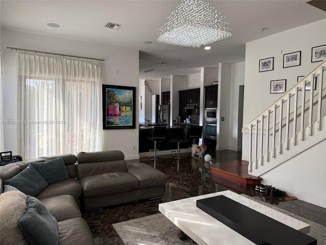 living area with baseboards, recessed lighting, a textured ceiling, stairs, and visible vents