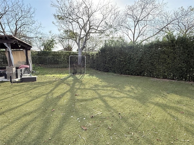view of yard featuring a gazebo and fence