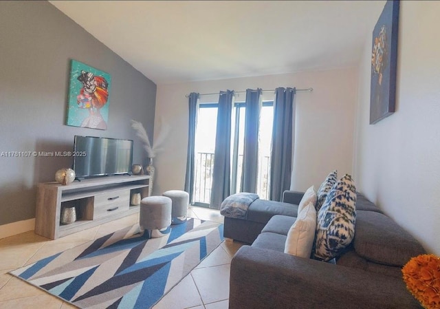living room featuring light tile patterned floors and vaulted ceiling