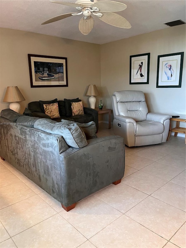 living room with visible vents, a ceiling fan, and light tile patterned flooring