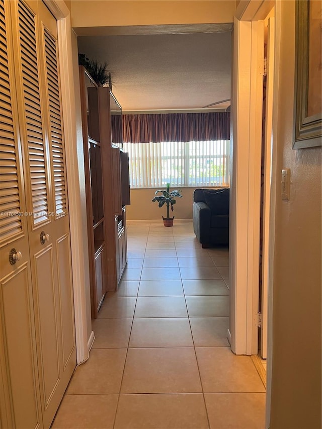 hallway with light tile patterned floors
