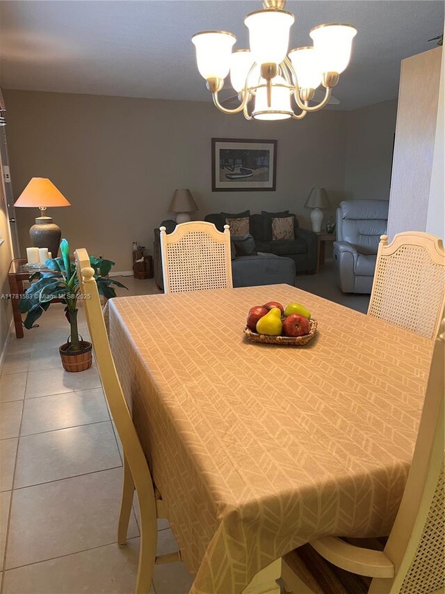 tiled dining area featuring an inviting chandelier