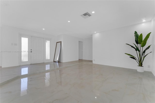 unfurnished room featuring visible vents, recessed lighting, and marble finish floor