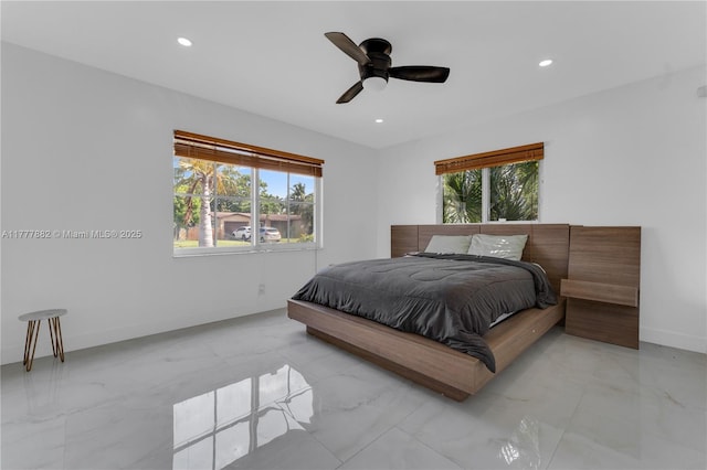 bedroom featuring recessed lighting, marble finish floor, and multiple windows