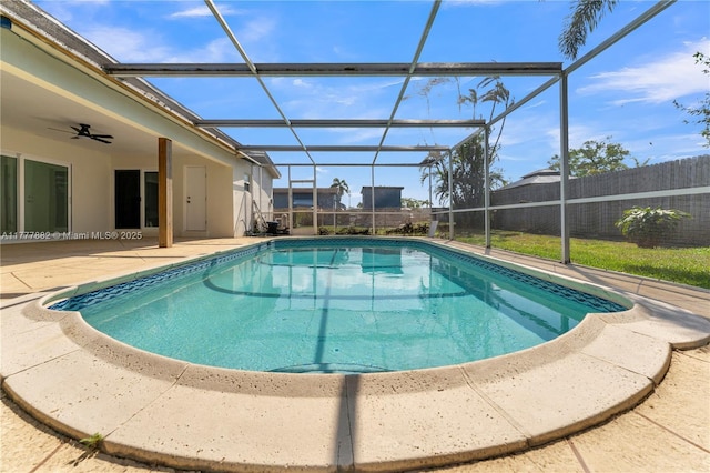 view of pool featuring a patio area, a ceiling fan, fence, glass enclosure, and a fenced in pool