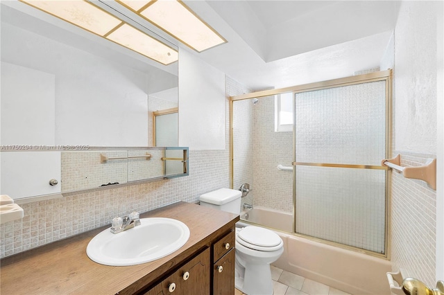 5300 Adams St, Hollywood, FL 33021 - bathroom with toilet, shower / bath combination with glass door, vanity, tile patterned floors, and tile walls