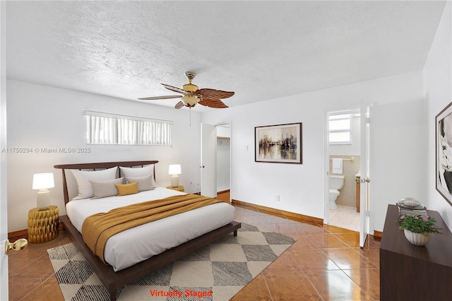 5300 Adams St, Hollywood, FL 33021 - bedroom with light tile patterned flooring, a textured ceiling, baseboards, a ceiling fan, and a walk in closet