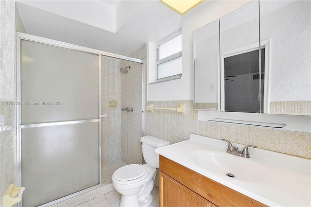 5300 Adams St, Hollywood, FL 33021 - bathroom featuring a shower stall, toilet, tile walls, vanity, and tile patterned floors