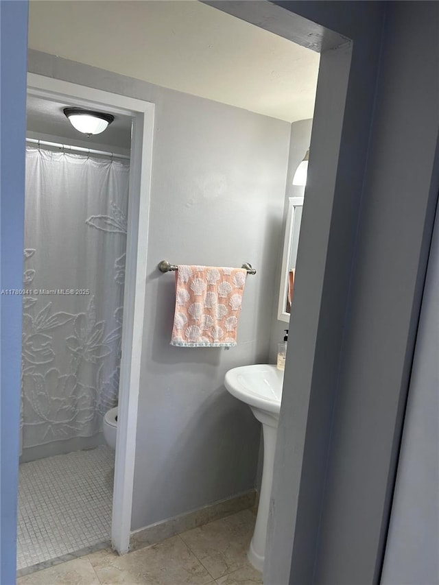 2899 Collins Ave Unit 708, Miami Beach, FL 33140 - bathroom featuring curtained shower and tile patterned floors
