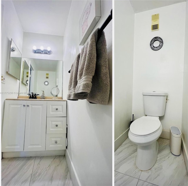 bathroom featuring marble finish floor, baseboards, and toilet