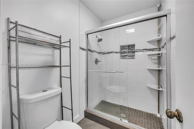 full bathroom with toilet and a stall shower