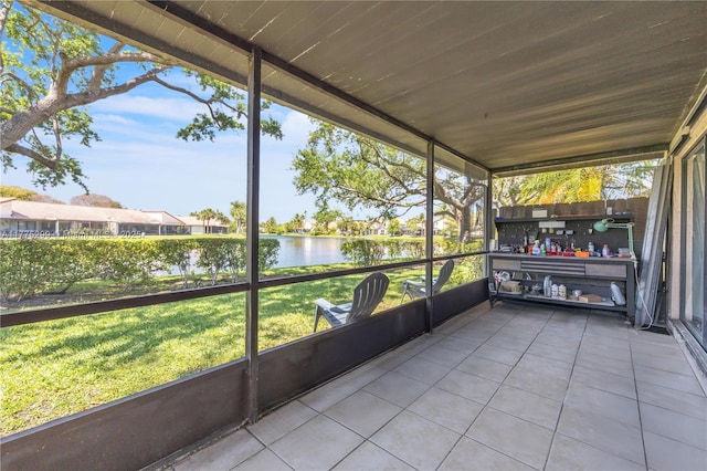 unfurnished sunroom with a water view