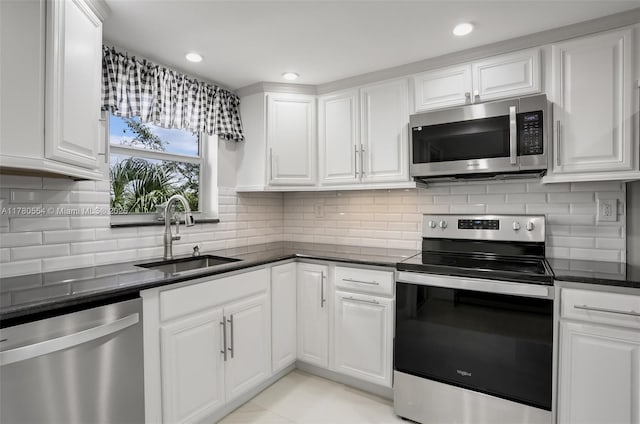 kitchen with white cabinets, recessed lighting, a sink, and appliances with stainless steel finishes
