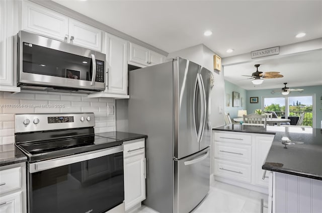 kitchen featuring a ceiling fan, white cabinets, recessed lighting, stainless steel appliances, and backsplash
