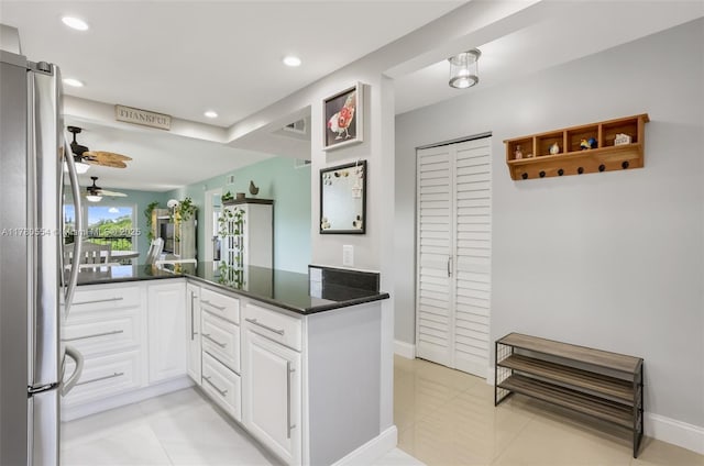 kitchen featuring recessed lighting, white cabinetry, freestanding refrigerator, a ceiling fan, and dark countertops