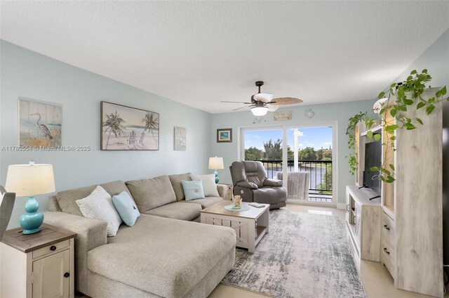 living area featuring a ceiling fan