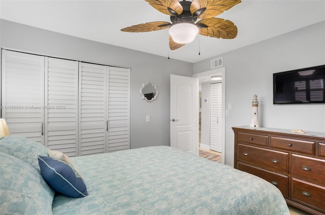 bedroom with visible vents, a closet, and ceiling fan