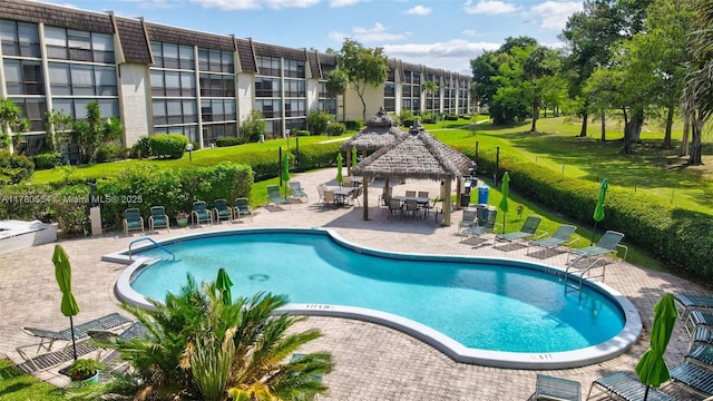 community pool featuring a patio area, a gazebo, and fence