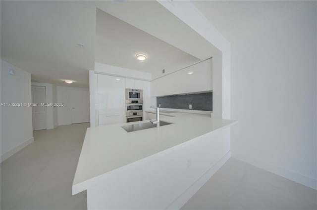 300 Sunny Isles Blvd Unit 4-1904, Sunny Isles Beach, FL 33160 - kitchen with a sink, modern cabinets, white cabinets, light countertops, and baseboards