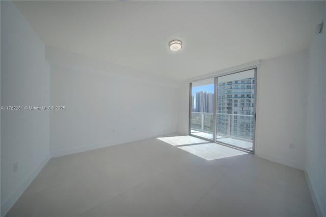 300 Sunny Isles Blvd Unit 4-1904, Sunny Isles Beach, FL 33160 - spare room with expansive windows, a view of city, baseboards, and concrete flooring