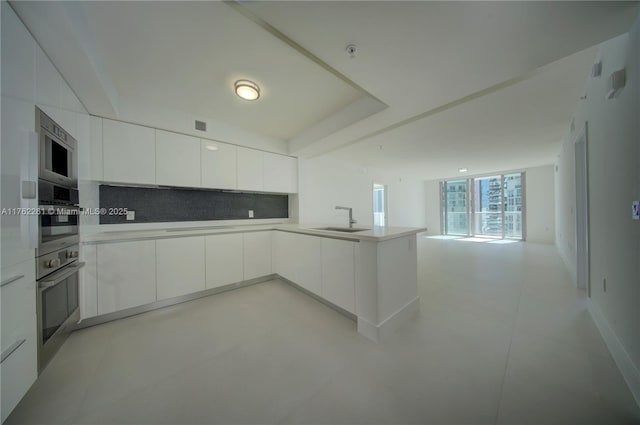 300 Sunny Isles Blvd Unit 4-1904, Sunny Isles Beach, FL 33160 - kitchen with a sink, open floor plan, modern cabinets, white cabinetry, and a peninsula