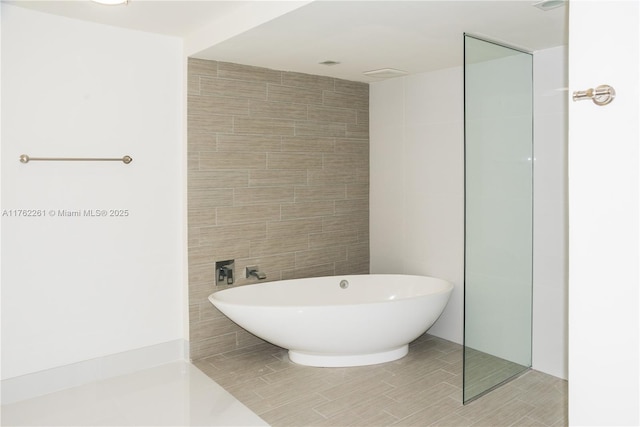 300 Sunny Isles Blvd Unit 4-1904, Sunny Isles Beach, FL 33160 - full bathroom with a soaking tub, tile walls, and tile patterned floors
