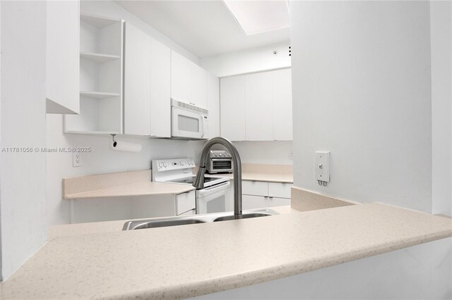 1 Century Ln Unit 309, Miami Beach, FL 33139 - kitchen with white cabinets, open shelves, white appliances, and modern cabinets