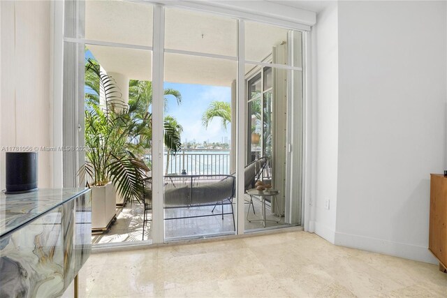1 Century Ln Unit 309, Miami Beach, FL 33139 - doorway to outside with a water view, baseboards, and plenty of natural light