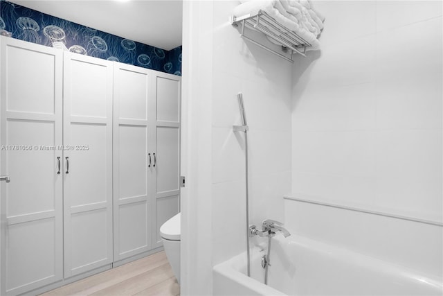 1 Century Ln Unit 309, Miami Beach, FL 33139 - bathroom featuring toilet, wood finished floors, and shower / bathtub combination