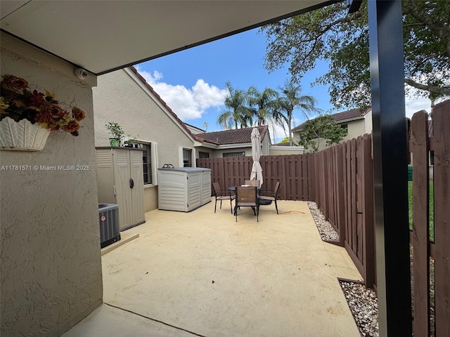 17012 NW 66th Ct, Hialeah, FL 33015 - view of patio featuring cooling unit, outdoor dining space, and a fenced backyard